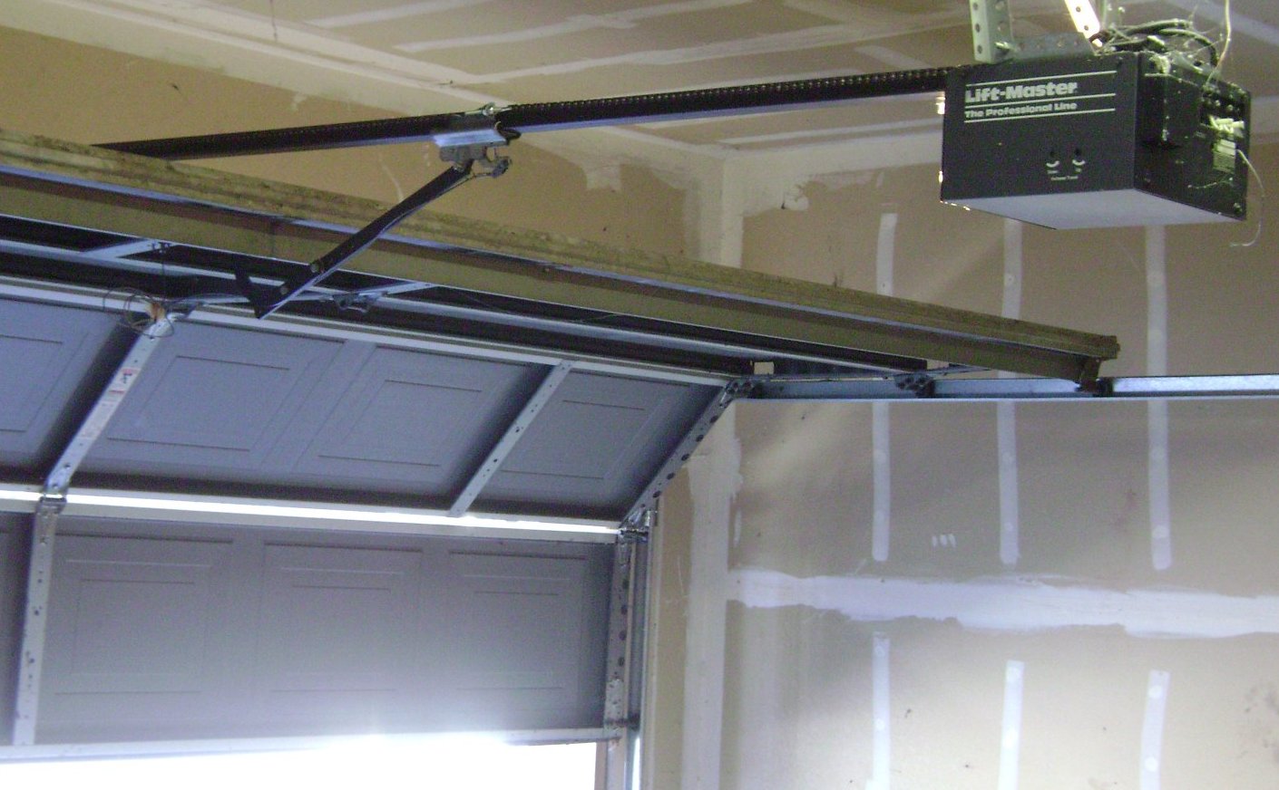 Ceiling-mounted garage door opener, the unit installed during a garage door opener installation on a Jacksonville, Florida home